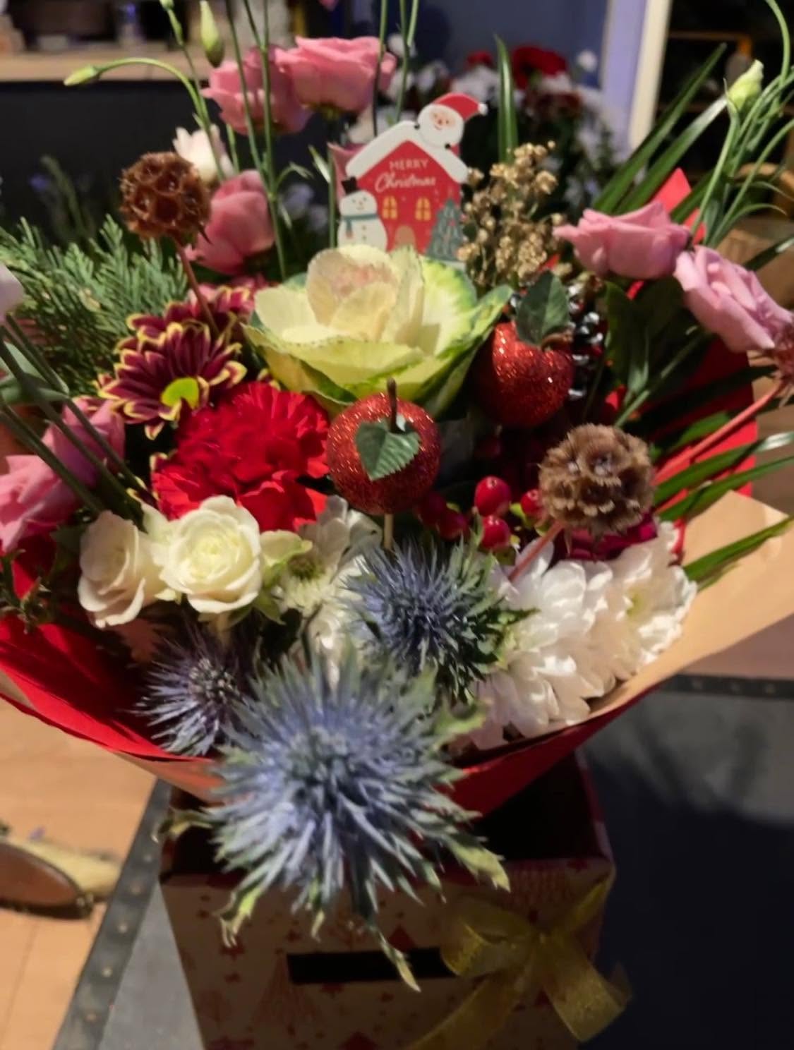 Festive box arrangement with a santa pick